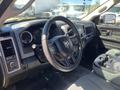 Interior view of a 2015 RAM 1500 with a black steering wheel and dashboard controls visible