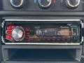 A Pioneer car stereo featuring a digital display and various control knobs and buttons installed in the dashboard of a vehicle