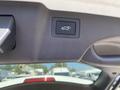 A close-up view of a button located on the interior of a 2018 Hyundai Santa Fe used to open the rear hatchback