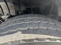 Close-up of a heavily treaded tire from a 2013 International WorkStar showing significant wear and texture on its surface