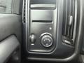 Dashboard controls of a 2015 GMC Sierra 1500 featuring a light control switch and a dial for automatic headlights