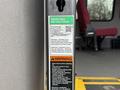 A close-up of a metal post displaying operating instructions and warnings for the lift system of a 2017 Ford E450 vehicle