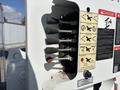 A close-up of control levers on a 2019 Freightliner M2 106 detailing various functions labeled with danger signs and emergency instructions