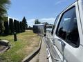 A white 1995 Ford F-250 truck with a chrome side mirror facing towards the right