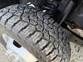Close-up of a rugged tire with deep tread patterns from a 2018 Ford F-350 showcasing its durable off-road capabilities