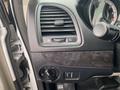 Interior detail of a 2014 RAM Cargo Van showing controls for air conditioning and a dashboard with air vents and a speedometer