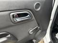 Close-up view of the door handle and interior features of a 2011 Chevrolet Colorado including the door lock and speaker