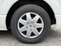 A close-up view of a silver alloy wheel mounted on a 2009 Toyota Hiace with a black tire featuring the Bridgestone logo