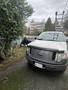 A 2011 Ford F-150 truck parked on a driveway with a silver exterior and a black grille