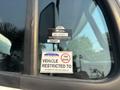 A 2016 Freightliner M2 106 with a certificate of approval sticker and a vehicle speed restriction sticker on the driver's side window