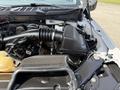 Close-up of the engine bay of a 2021 Ford F-150 showing the air intake system and various engine components