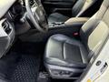 Interior of a 2021 Toyota C-HR featuring black leather seats with a textured design and a dashboard with modern controls and a steering wheel