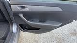 The interior door panel of a 2018 Hyundai Sonata featuring a handle and cup holder