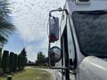 A 2011 Workhorse W62 vehicle with a side mirror and a red warning light mounted on the side