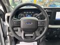 Steering wheel of a 2023 Ford F-450 Super Duty with control buttons and Ford logo visible