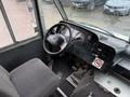 Interior view of a 2012 Ford Econoline showing the driver's seat dashboard and steering wheel with various controls visible