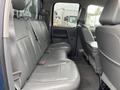 Interior view of a 2006 Dodge Ram 2500 showing the backseat area with gray leather seats and a central armrest