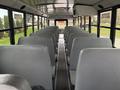 Interior view of a 2022 Freightliner B2 school bus featuring rows of gray seating with a clear aisle in the center