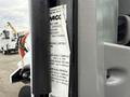 A 2016 Peterbilt 348 truck door with a visible compliance label detailing emissions control and regulatory information