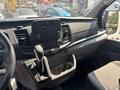 Interior view of a 2025 Ford Transit T-350 focusing on the dashboard with a touchscreen display and gear shifter