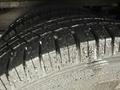 Close-up of a tire from a 2020 Chevrolet Express showing deep treads with water droplets on the surface