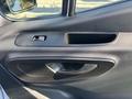 Interior door handle and controls of a 2021 Mercedes-Benz Sprinter 2500 showcasing a sleek design with a textured surface and modern aesthetics