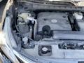 A 2017 Nissan Murano engine compartment showing the V6 engine with various components including hoses and fluids