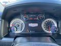 Dashboard of a 2017 RAM 1500 featuring speedometer tachometer fuel gauge and warning lights with a central display showing the logo Laramie