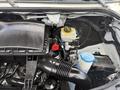 A 2016 Mercedes-Benz Sprinter engine compartment featuring various components including the air intake housing coolant reservoir and fluid containers