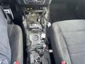 A 2015 Dodge Charger interior with a partially disassembled center console showing exposed wiring and electronic components