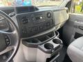 Interior view of a 2013 Ford E-350 Super Duty dashboard featuring controls and cup holders