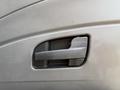 A close-up view of the door handle on a 2011 International 4300 truck featuring a textured black design and a rectangular shape