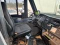 Interior view of a 2007 Freightliner B2 truck showing the driver's seat dashboard controls and steering wheel
