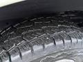 Close-up of a treaded tire from a 2016 GMC Savana showcasing deep grooves and textured surface for enhanced traction