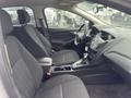 Interior of a 2018 Ford Focus showing front seats and dashboard with steering wheel and gear shift in focus