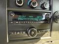 Dashboard of a 2017 Chevrolet Express showing a car stereo display with radio station information and control knobs