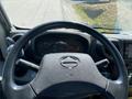 Steering wheel and dashboard of a 2014 Hino 195 displaying gauges and indicators