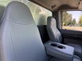 Interior view of a 2017 Ford F-650 Super Duty showing two gray front seats and a center console with cup holders