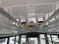 Interior view of a 2021 Ford Econoline showing the ceiling with air vents and signage for emergency exits