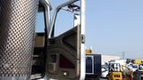 A 2003 International 5600i truck with an open door showing the interior details and driver's seat