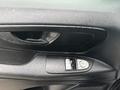 Interior door panel of a 2021 Mercedes-Benz Metris featuring window control buttons and a lock switch