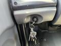 A close-up of a 2007 Freightliner M2 106 ignition switch with keys inserted and additional keys hanging on a keychain