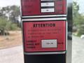 A safety label on a 2012 Caterpillar 980 detailing wheel nut torque specifications and maintenance instructions for operation