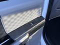 A close-up view of the door handle and window control switch on the door panel of a 2020 Ford F-350