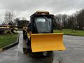 A 2015 Camoplast SW 4S snowplow with a yellow blade attached in the foreground