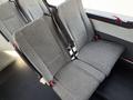 Interior seat of a 2021 Ford Econoline van with a grey patterned fabric and seatbelts visible