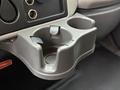 A gray cup holder with a removable plastic insert designed to hold drinks in the front of a 2014 International TerraStar truck