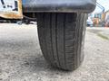 Close-up of a tire from a 2016 Genie TZ-34/20 showing tread patterns and wear on the surface