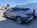 A 2017 Nissan Murano in gray parked with its rear angled towards the viewer showcasing its distinctive tail lights and sleek body design