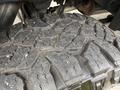 Close-up of a rugged tire tread of a 2017 Chevrolet Silverado 1500 showcasing deep grooves and robust design for off-road traction